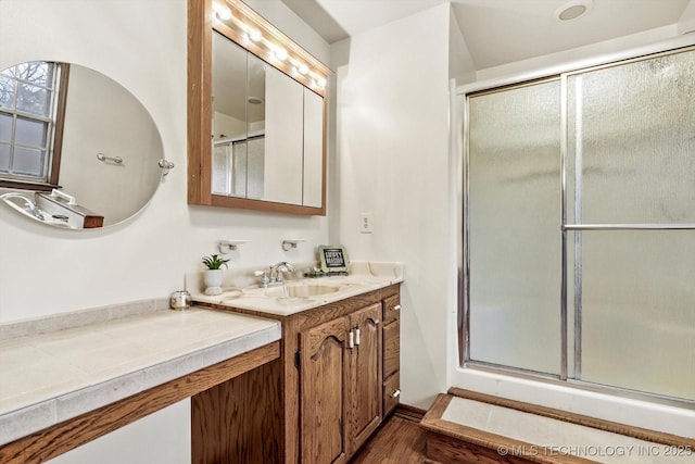 17121 E 120th St, Collinsville, OK 74021 - bathroom featuring a shower with door, vanity, and wood finished floors