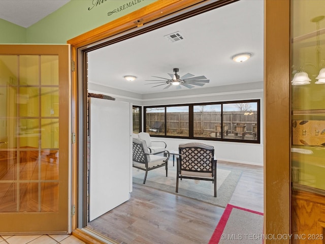 sunroom featuring ceiling fan