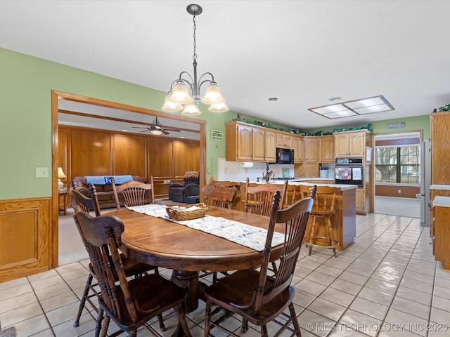 dining space with ceiling fan and light tile patterned floors