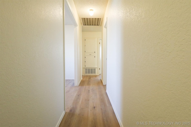 hallway with light hardwood / wood-style flooring