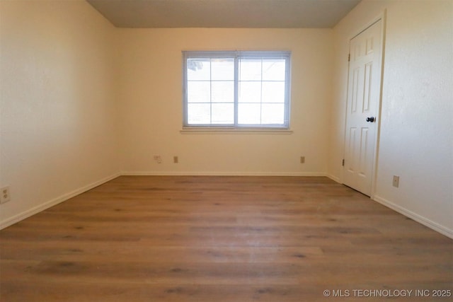 spare room featuring hardwood / wood-style flooring