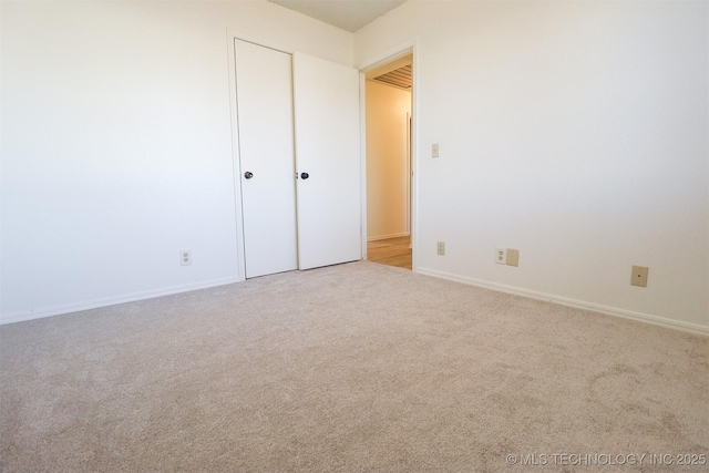 unfurnished bedroom with light carpet