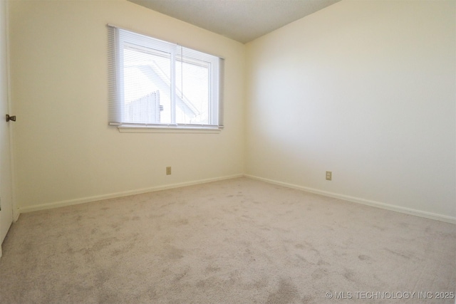 empty room with vaulted ceiling and carpet floors