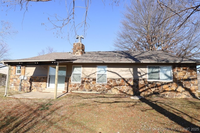 rear view of property featuring a yard and a patio area