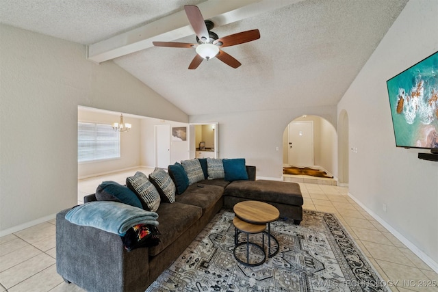 tiled living room with ceiling fan with notable chandelier, a textured ceiling, and vaulted ceiling with beams