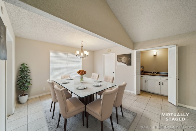 tiled dining room featuring lofted ceiling, sink, a textured ceiling, and a chandelier