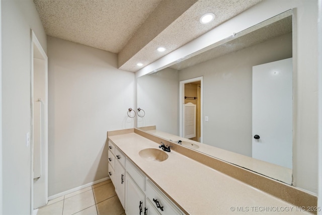 bathroom featuring vanity, tile patterned floors, and a textured ceiling