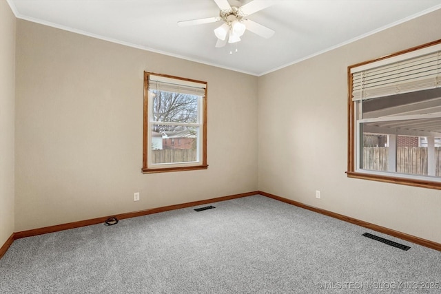 carpeted empty room with ceiling fan and ornamental molding