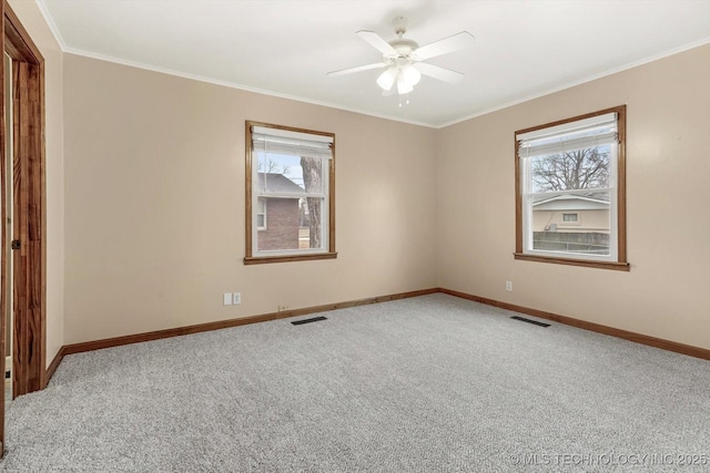 carpeted empty room featuring crown molding and ceiling fan