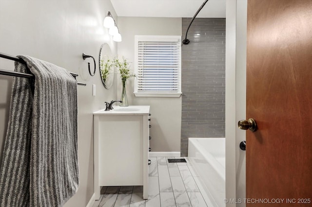 bathroom with vanity and tiled shower / bath combo