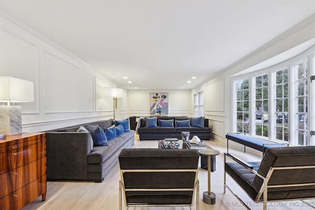 living room featuring crown molding and light wood-type flooring