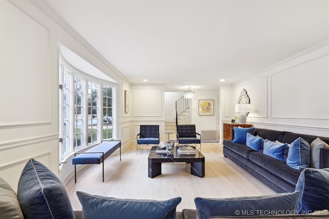 living room featuring ornamental molding and light wood-type flooring