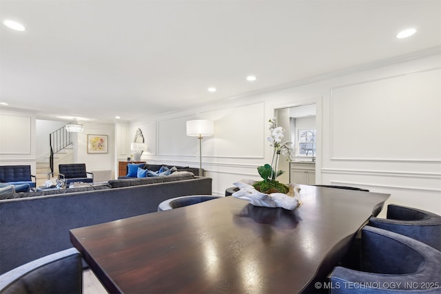 dining room with ornamental molding and sink