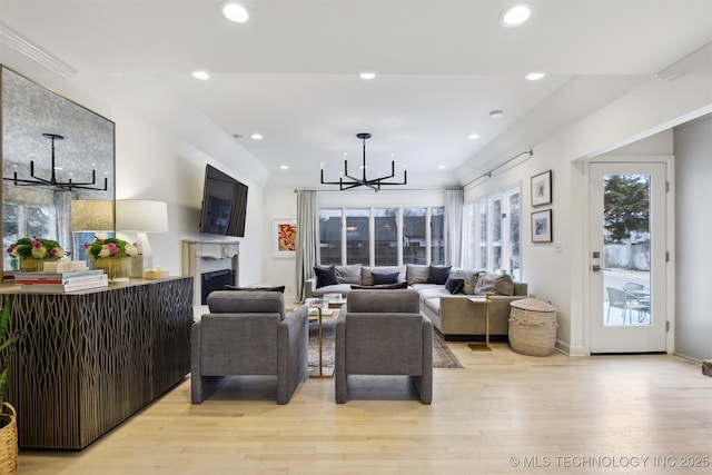 living room featuring an inviting chandelier and light wood-type flooring