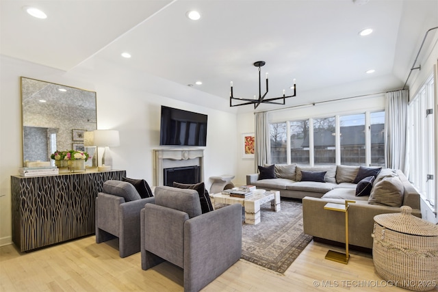 living room featuring an inviting chandelier and light hardwood / wood-style floors