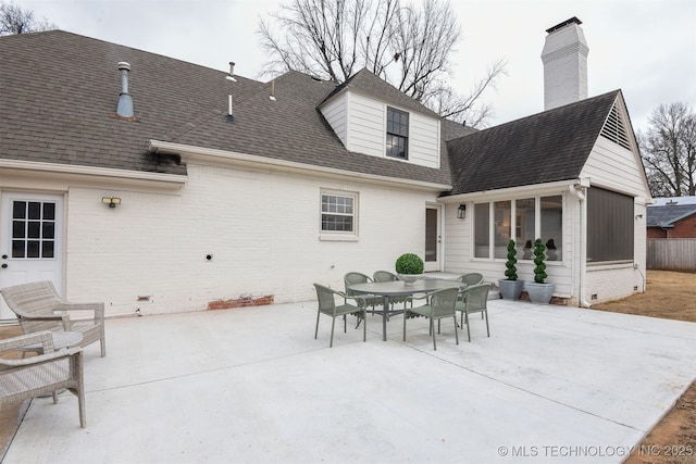 back of property with a patio