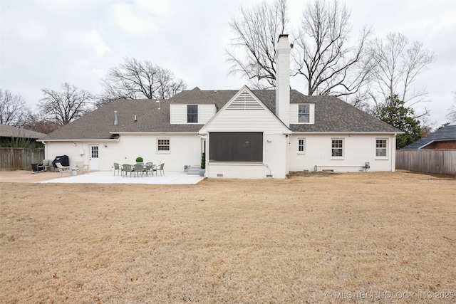 back of property with a patio area and a lawn