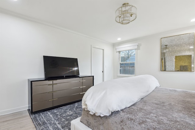 bedroom with hardwood / wood-style flooring and ornamental molding