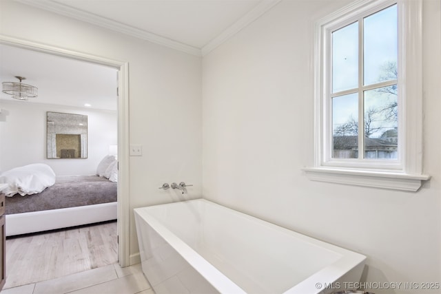 bathroom with ornamental molding, a washtub, and tile patterned floors