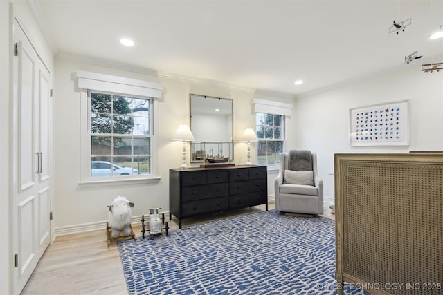 living area with crown molding and hardwood / wood-style flooring