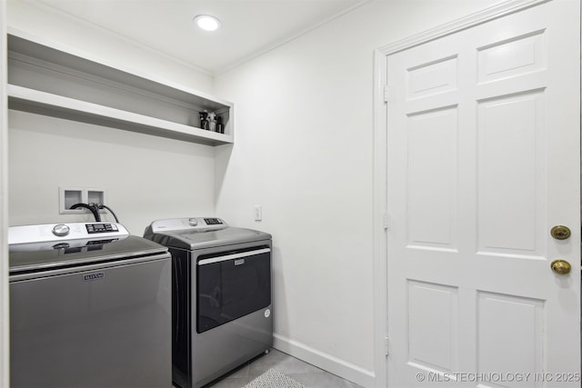 clothes washing area with washing machine and dryer