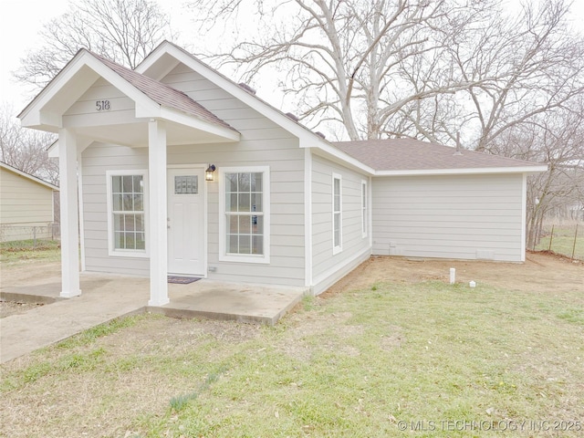 view of front of property with a patio area and a front lawn