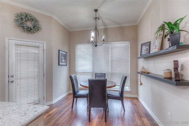 dining space featuring crown molding, dark wood-type flooring, and a notable chandelier