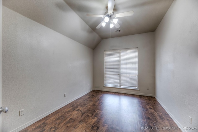 spare room with ceiling fan, dark hardwood / wood-style flooring, and vaulted ceiling