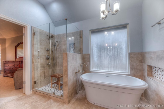 bathroom featuring lofted ceiling, plus walk in shower, tile patterned flooring, and tile walls