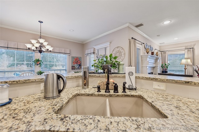 kitchen featuring an inviting chandelier, sink, decorative light fixtures, and a healthy amount of sunlight