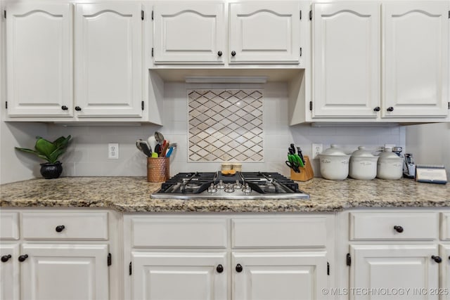 kitchen featuring white cabinetry, light stone countertops, stainless steel gas cooktop, and tasteful backsplash