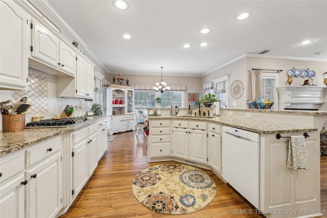 kitchen with white cabinetry, dishwasher, stainless steel gas cooktop, and hanging light fixtures