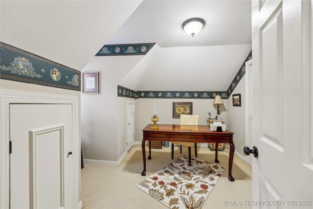 carpeted office space with lofted ceiling