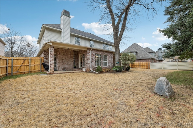 rear view of house with a lawn