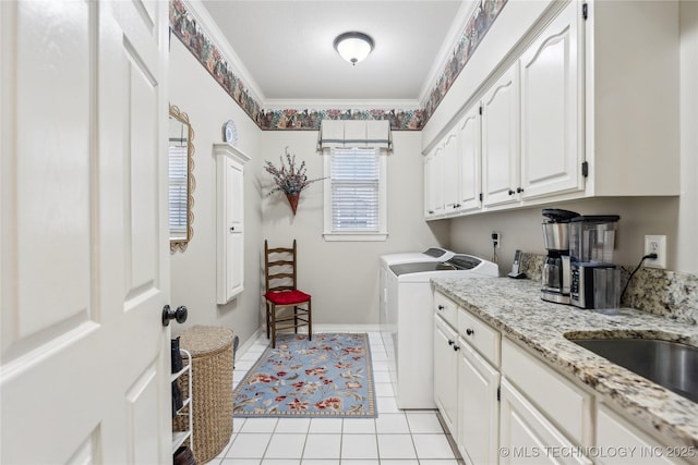 laundry area featuring independent washer and dryer, crown molding, cabinets, and light tile patterned floors