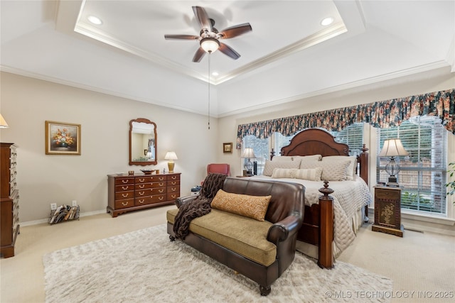 carpeted bedroom featuring a raised ceiling, crown molding, and ceiling fan