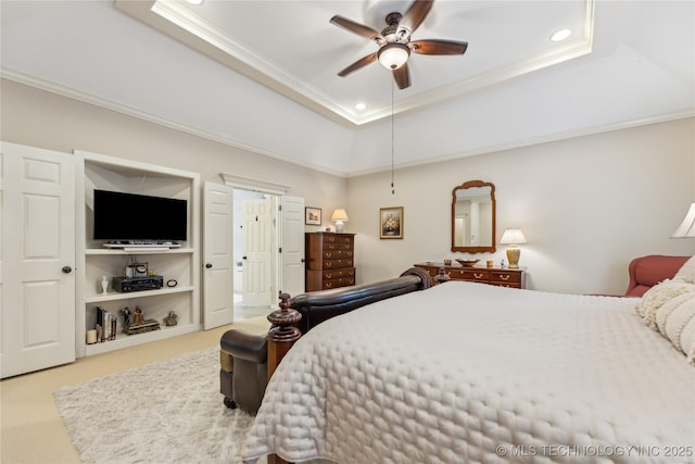 bedroom with crown molding, ceiling fan, a raised ceiling, and carpet