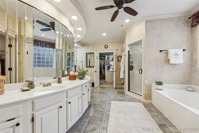 bathroom with ceiling fan, ornamental molding, plus walk in shower, and vanity