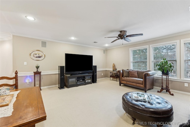 carpeted living room featuring ornamental molding and ceiling fan