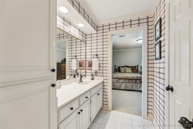 bathroom featuring tile patterned flooring, crown molding, and vanity