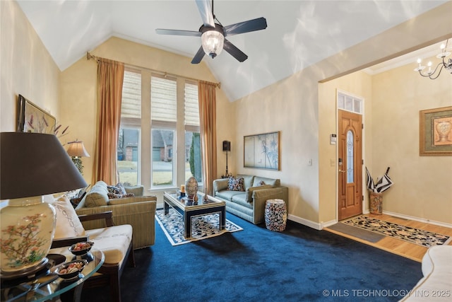 living room with ceiling fan with notable chandelier, dark hardwood / wood-style floors, and vaulted ceiling