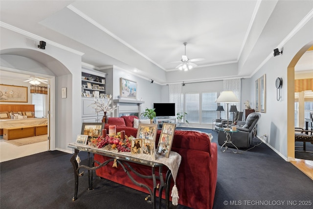 living room featuring crown molding and ceiling fan