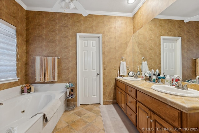 bathroom with ornamental molding, vanity, ceiling fan, and a tub to relax in