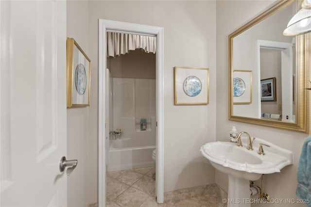 bathroom featuring shower / tub combination, tile patterned floors, and toilet