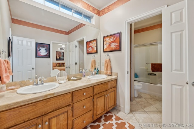 full bathroom featuring tile patterned flooring, vanity, shower / bath combination with glass door, and toilet