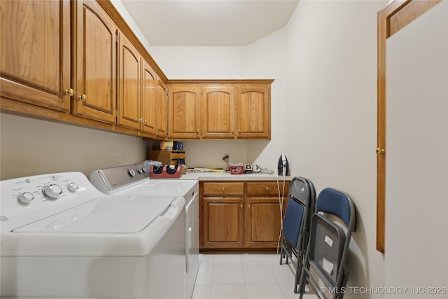 laundry room featuring cabinets, light tile patterned floors, and independent washer and dryer