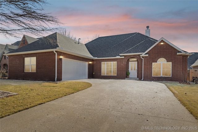 view of front facade with a garage and a yard