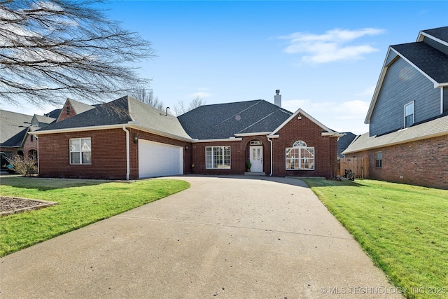 view of front of property featuring a garage and a front lawn