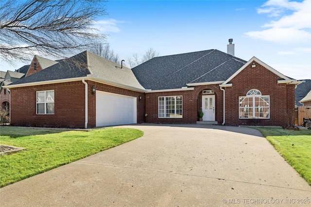 view of front of home featuring a garage and a front lawn