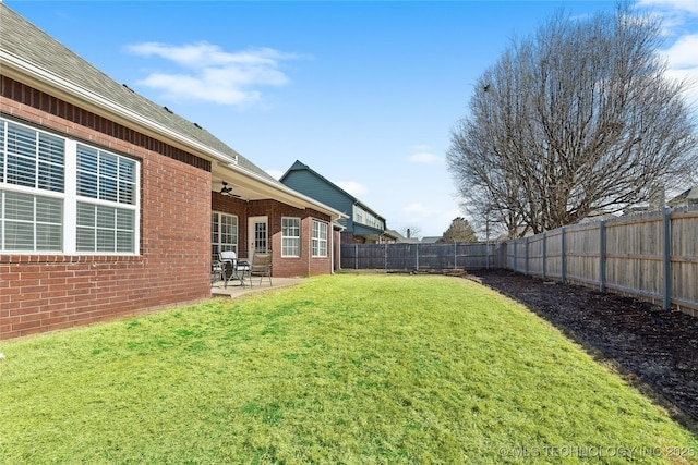 view of yard featuring a patio and ceiling fan